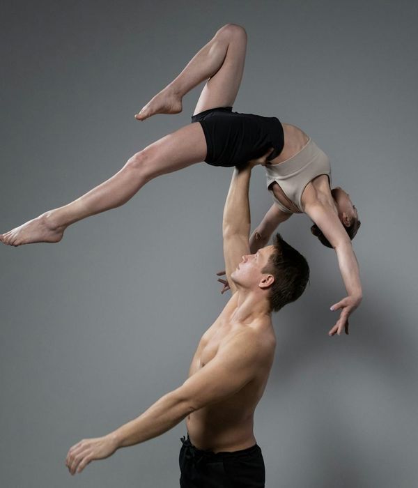 A woman performing a graceful yoga balance in a serene environment